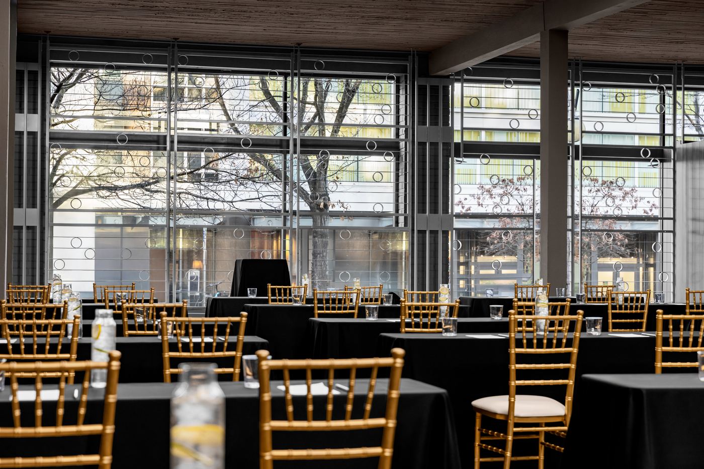 Palladian Arthouse event hall set for corporate meeting with black linen tables overlooking Belltown Seattle
