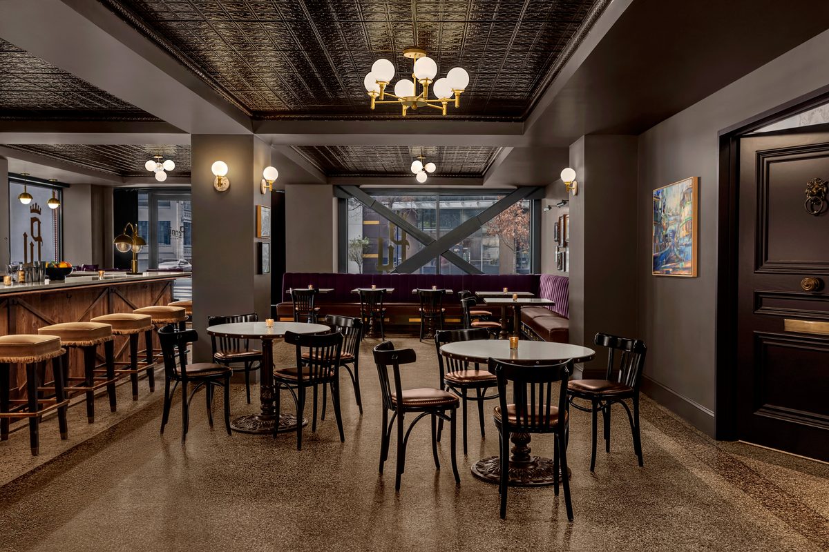 PennyRoyal cocktail bar and lounge interior with ornate tin ceiling, brass chandelier and vintage bar stools